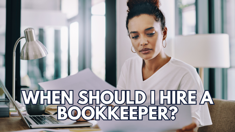 Self-employed woman reviewing financial documents, weighing the pros and cons of hiring a certified bookkeeper versus using bookkeeping software.